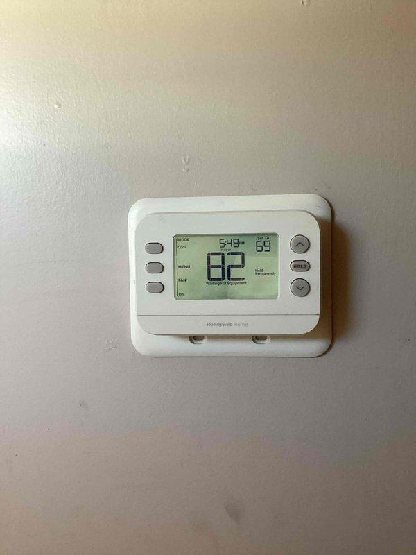 Relocated Honeywell Home digital thermostat to proper mounting location. Accessed wall cavity to run thermostat wiring through interior wall structure and insulation. Return visit required to complete final thermostat mounting and wall repair at new location.