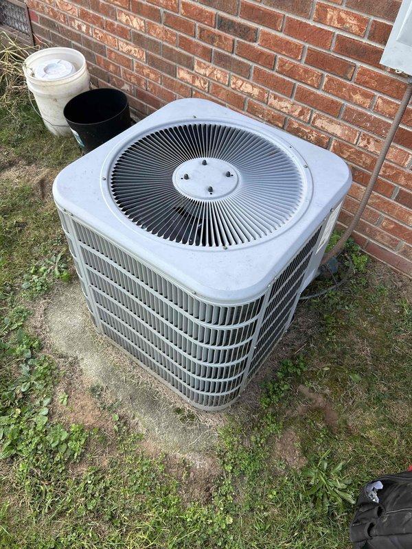 Responded to no cooling complaint and performed diagnostic evaluation of split system air conditioning unit. Inspected outdoor condenser unit and indoor air handler, documented refrigerant lines showing signs of corrosion and discoloration on piping. System components photographed for service records, including condenser unit positioned on concrete pad with louvered grilles and indoor air handler installation in mechanical room.