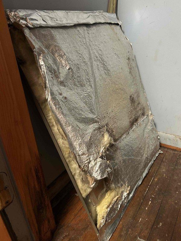 Responded to callback for unusual noise from indoor air handler unit following recent maintenance. Upon inspection, discovered deteriorated foil-faced insulation material had separated from ductwork and debris had entered the blower motor assembly. Removed insulation debris from motor housing and verified motor operation. Assessed condition of existing duct insulation, which showed extensive foil layer damage, tears, and separation from foam backing. Removed compromised insulation sections to prevent further contamination of system components. Unit tested and confirmed normal operation with no abnormal noise present at time of departure.