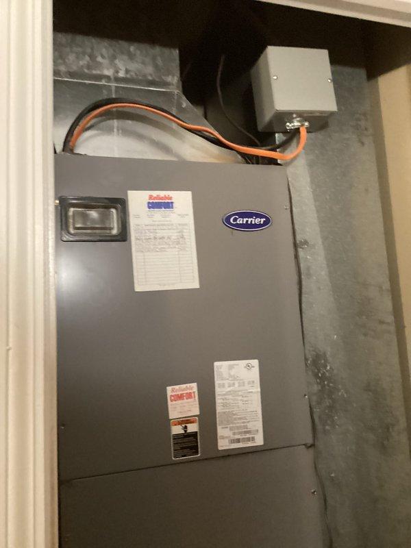 Completed basic monthly cooling maintenance on Carrier HVAC unit. Inspected blower wheel assembly and housing, confirming proper operation with minimal debris accumulation on components. Replaced 20x21x1 air filter, verified system operation, and documented equipment condition with unit showing normal wear for residential cooling system.