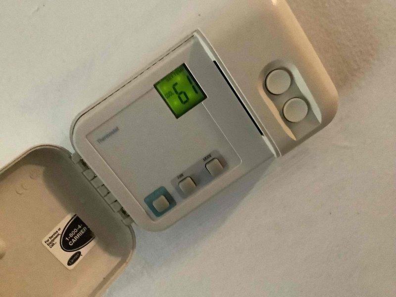 Responded to trouble call for air conditioning system not functioning properly. Performed diagnostic inspection of HVAC system including thermostat operation and air handler unit. Documented existing equipment configuration with Honeywell digital thermostat and air handler installation including condensate drain line, electrical connections, and ductwork connections for service records.