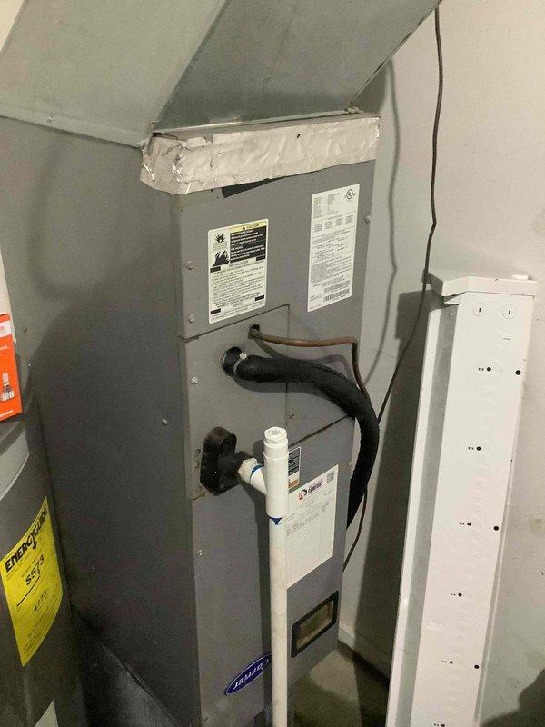 Responded to trouble call for air conditioning system not functioning properly. Performed diagnostic inspection of HVAC system including thermostat operation and air handler unit. Documented existing equipment configuration with Honeywell digital thermostat and air handler installation including condensate drain line, electrical connections, and ductwork connections for service records.