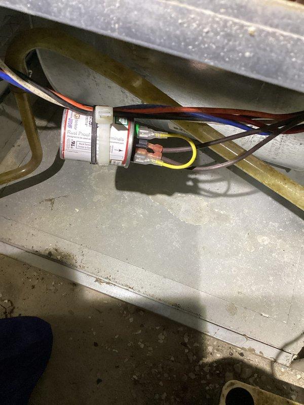 # HVAC Maintenance - Heating System Service

Completed basic monthly heating maintenance visit on residential HVAC system. Performed comprehensive visual inspection of heat exchanger assembly, confirming copper U-bend tubes showed age-appropriate oxidation and patina but remained structurally sound with no visible leaks or damage detected. Inspected aluminum finned coil assembly behind heat exchanger, verifying fin spacing and condition were acceptable for continued operation.

Examined electrical wiring connections and routing throughout system, confirming all wire bundles were properly secured and routed through designated pathways. Verified color-coded wiring (blue, orange, brown, and yellow conductors) maintained proper connections at junction points and terminations. Inspected white cylindrical connector assembly for secure attachment and proper labeling.

Assessed ductwork housing and surrounding mechanical components for dust accumulation and general wear. All electrical connect