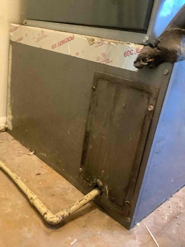 Responded to no-cooling call on aging air conditioning system at recently purchased property. Performed diagnostic evaluation of non-operational unit, accessed system components through utility area panel, and conducted pressure testing using manifold gauges at outdoor condensing unit. Unit inoperable with unknown service history; recommended system replacement due to age and condition of equipment.