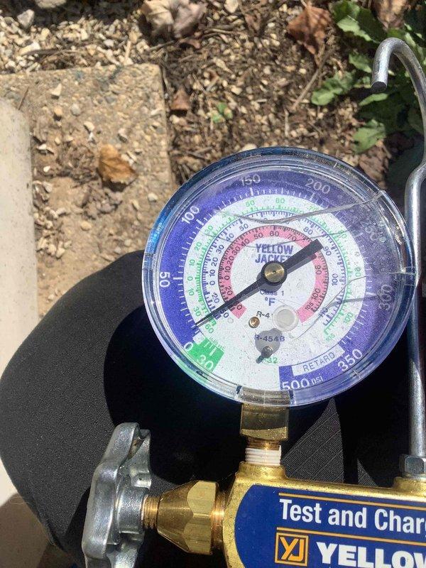 Responded to no-cooling call on aging air conditioning system at recently purchased property. Performed diagnostic evaluation of non-operational unit, accessed system components through utility area panel, and conducted pressure testing using manifold gauges at outdoor condensing unit. Unit inoperable with unknown service history; recommended system replacement due to age and condition of equipment.