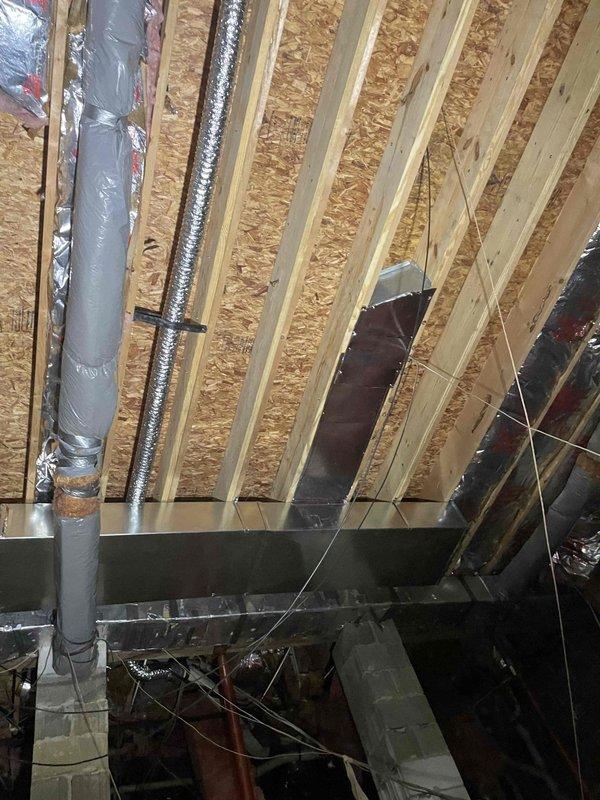 Reconnected return duct system in attic space and installed new return pan with proper sealing. Reconnected kitchen supply duct piping and rerouted dryer vent to discharge outside the structure using new vent piping and exterior termination. Installed two sections of 10x20 metal ductwork and secured all connections with appropriate fasteners and supports to ensure proper airflow and code compliance.