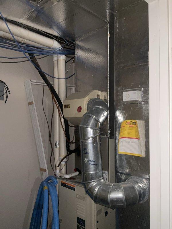 Conducted comprehensive evaluation of existing upstairs HVAC system for replacement estimate following multiple previous repairs including refrigerant leak repair and two capacitor replacements. Assessed horizontal air handler unit located in attic space and interior air handling equipment in utility closet, documenting current system configuration with metallic ductwork, refrigerant lines with filter drier, condensate drain lines, and electrical connections. Prepared replacement options for upstairs air conditioning system only, as well as complete system replacement alternatives for both zones per customer request.