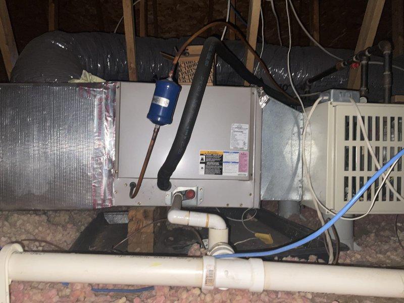 Conducted comprehensive evaluation of existing upstairs HVAC system for replacement estimate following multiple previous repairs including refrigerant leak repair and two capacitor replacements. Assessed horizontal air handler unit located in attic space and interior air handling equipment in utility closet, documenting current system configuration with metallic ductwork, refrigerant lines with filter drier, condensate drain lines, and electrical connections. Prepared replacement options for upstairs air conditioning system only, as well as complete system replacement alternatives for both zones per customer request.
