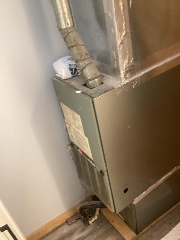 Performed annual maintenance on aging residential forced-air furnace system experiencing clanging noises during startup. Completed thorough blowout and cleaning of unit to remove accumulated dust and debris from burner assembly, heat exchanger, and blower compartment. Verified proper operation of Honeywell ProSeries thermostat set to 73 degrees and confirmed system cycling without abnormal sounds following service.