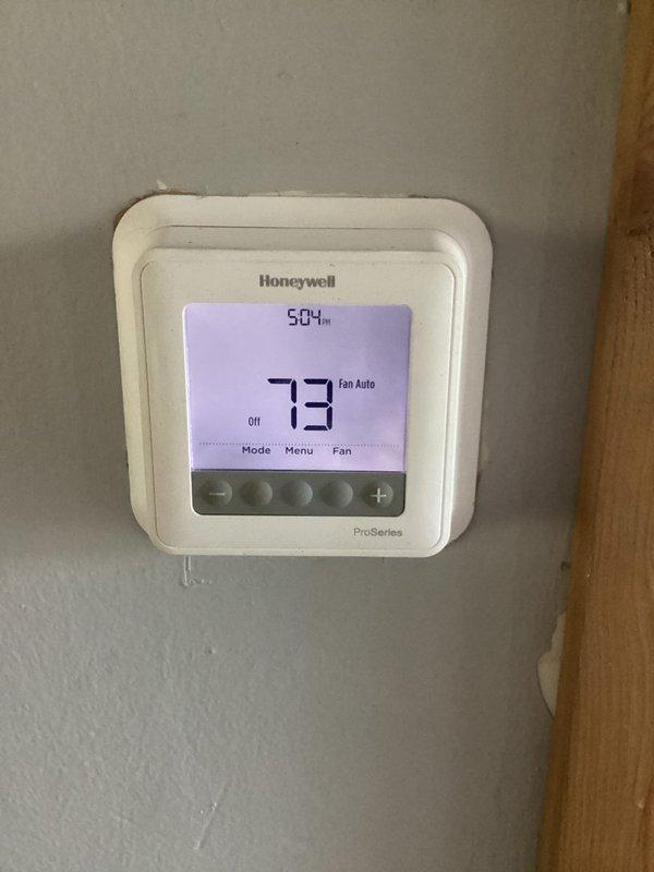 Performed annual maintenance on aging residential forced-air furnace system experiencing clanging noises during startup. Completed thorough blowout and cleaning of unit to remove accumulated dust and debris from burner assembly, heat exchanger, and blower compartment. Verified proper operation of Honeywell ProSeries thermostat set to 73 degrees and confirmed system cycling without abnormal sounds following service.