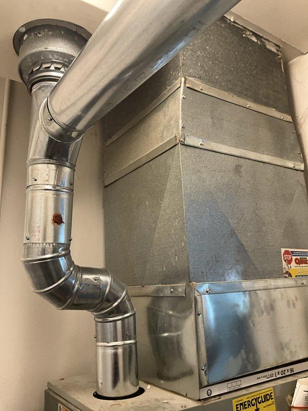 Conducted on-site evaluation of existing 1970s/1980s-era air conditioning system found to be depleted of R-22 refrigerant. Inspected residential HVAC equipment including furnace unit with 80.0 AFUE efficiency rating and associated ductwork system consisting of galvanized steel rectangular ducts and metallic flexible duct connections. Documented current system configuration through photographic assessment showing equipment housed in utility closet with standard installation components. Provided replacement estimates for complete AC system upgrade due to obsolete R-22 refrigerant requirements and age of existing equipment.