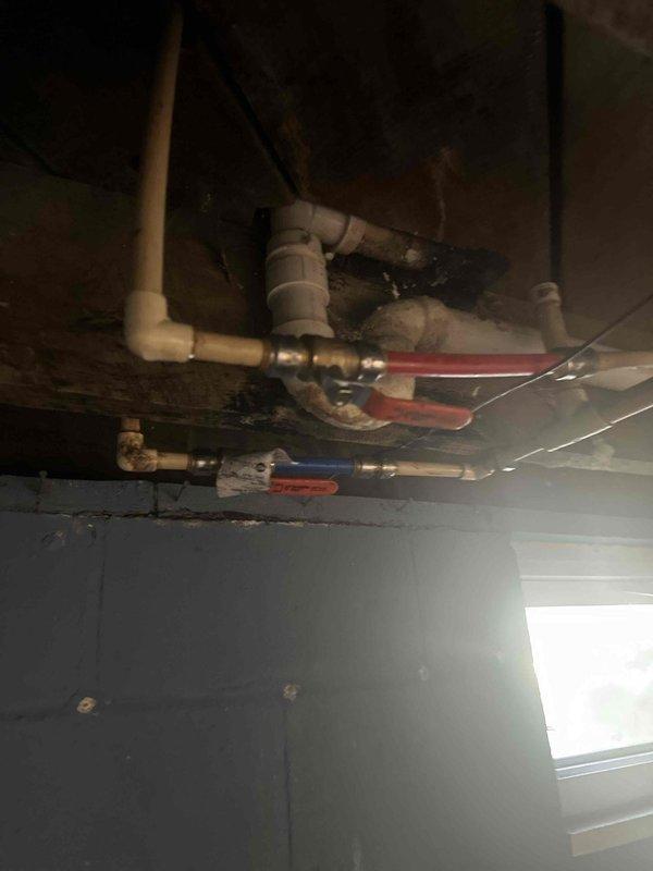 Responded to service call for non-functional shower controls. Upon inspection, determined that the shower valve cartridge had failed, preventing the control knobs from operating the water flow. Accessed the valve assembly from behind the wall through the basement plumbing access point. Shut off the water supply using the isolation valves, removed the deteriorated cartridge, and installed a replacement unit. Tested the shower controls for proper operation, confirmed full functionality of both hot and cold water flow and complete shut-off capability. Restored water supply and verified no leaks at connections.