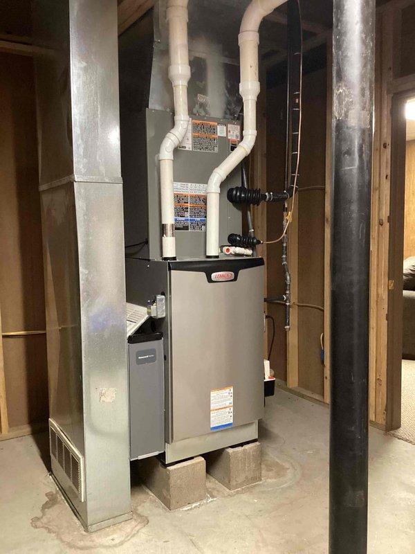 Completed annual basic heating maintenance visit on Lennox furnace system located in basement utility area. Performed standard heating season inspection including visual inspection of unit, heat exchanger, burner assembly, and all safety controls. Installed customer-provided 20x25x4 air filter as part of active comfort care plan. Verified thermostat operation showing system maintaining 69°F setpoint with proper communication to heating equipment. Inspected gas connections, condensate drainage system with PVC piping, and all electrical connections for proper operation. All components found operating within normal parameters with no immediate service needs identified. System ready for heating season operation.