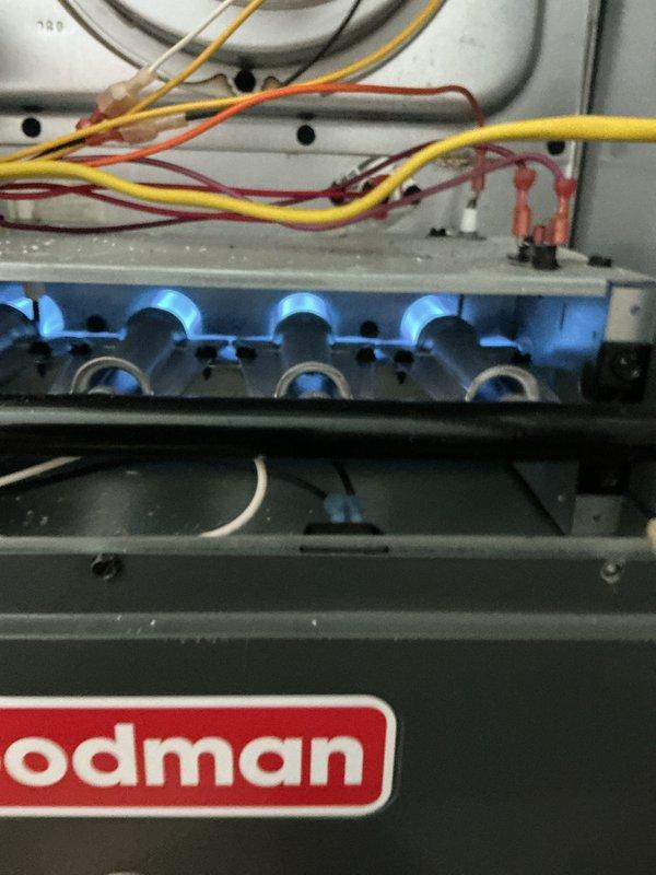Completed monthly basic heating maintenance visit on Goodman gas furnace system. Verified burner operation with all flames burning clean blue, confirmed proper ignition sequence, inspected electrical connections and wiring throughout unit, and checked Honeywell Home ProSeries thermostat functionality showing system maintaining 71°F setpoint on permanent hold with WiFi connectivity active at 43% signal strength. All components operating within normal parameters with no issues identified during this routine preventative maintenance service.