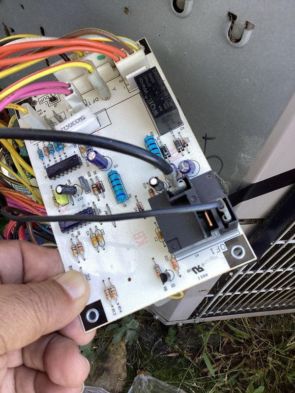 Responded to recurring condenser fan motor failure on Carrier heat pump unit. Upon arrival, confirmed compressor operating but condenser fan motor not running. Investigated thermal tripping issue affecting replacement motor that was previously installed. Performed diagnostic testing on fan motor circuit and control board to identify root cause of repeated thermal overload trips. Removed and inspected control boards, revealing potential issues with electronic components including capacitors and relay circuits that may be causing improper voltage or amperage delivery to fan motor. Documented control board condition with photos showing multiple circuit components and wiring connections. Determined that underlying electrical issue from control board or wiring is likely causing premature thermal protection activation on condenser fan motor rather than motor defect itself. This explains pattern of recurring failures despite motor replacement. Recommended control board replacement or further 