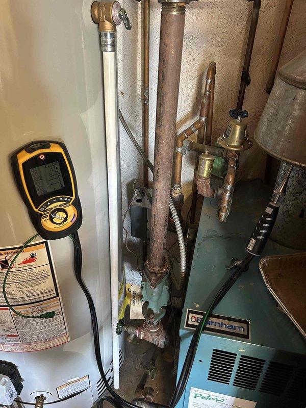 Performed operational assessment on Burnham boiler system to verify continued functionality while awaiting replacement unit. Conducted diagnostic testing using digital meter to evaluate combustion performance, temperature differentials, and system pressures. Inspected copper piping, brass fittings, and isolation valves for leaks or deterioration. Verified water heater connections and expansion tank condition. Confirmed boiler ignition sequence, burner operation, and proper venting through galvanized ductwork. System currently operational and safe for continued use pending new equipment installation.