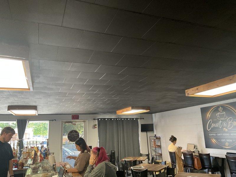 Conducted site assessment for mini split installation at commercial café space. Evaluated interior layout including ceiling structure with gray tile pattern, multiple skylights, and existing HVAC infrastructure. Documented entry area with concrete block walls and identified optimal placement zones for indoor air handler units and outdoor condensing unit connections. Provided estimate for ductless mini split system to enhance climate control in customer seating areas while maintaining aesthetic integration with contemporary café design.