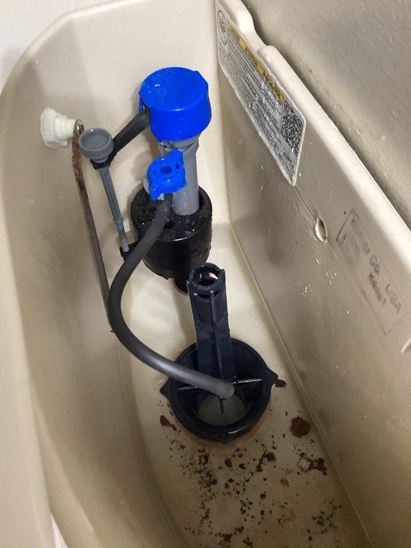 Responded to a non-functioning toilet that was unable to flush. Upon inspection, diagnosed a failed flush valve seal causing improper water release from the tank. Removed the old deteriorated flush valve gasket and replaced it with a new yellow rubber seal. Verified the fill valve assembly was operating correctly and inspected tank interior for any additional issues. Tested flush mechanism multiple times to confirm proper operation and complete water evacuation from tank to bowl. Toilet restored to full working condition.