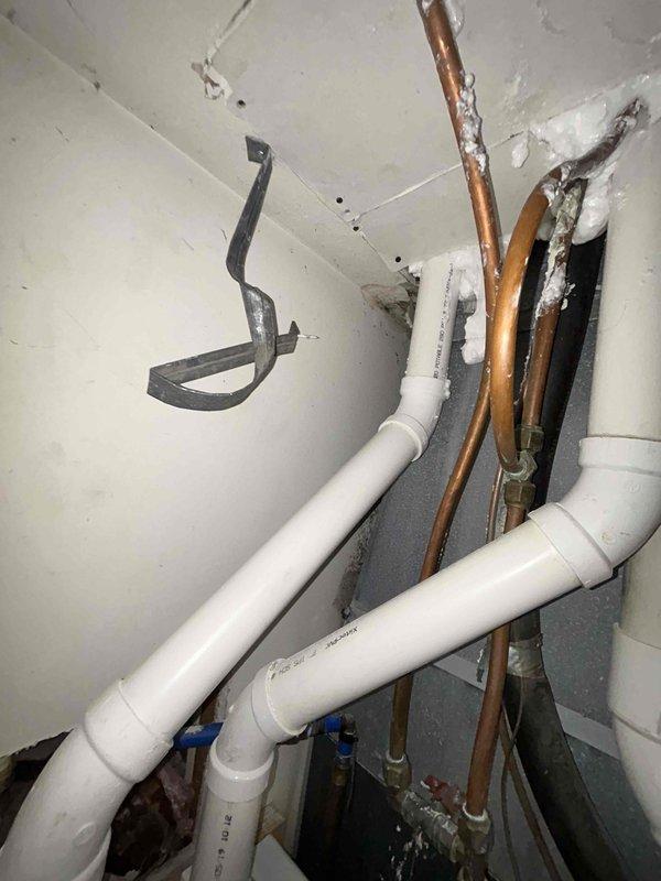 Responded to service call for recently installed air conditioning unit experiencing operational issues. Upon inspection, discovered significant moisture infiltration in wall cavity near HVAC system resulting in extensive mold growth and water damage to interior surfaces. Identified condensate drainage concerns with PVC drain lines and noted oxidized copper refrigerant lines with inadequate insulation contributing to condensation problems. Documented existing plumbing infrastructure conditions and moisture damage patterns for remediation recommendations.