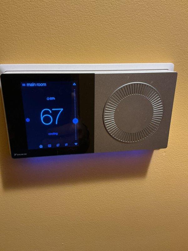 Completed basic monthly heating maintenance visit on Daikin HVAC system. Inspected return air grille and verified proper airflow through ventilation components. Checked digital thermostat operation, confirmed display functioning correctly showing 67°F setpoint with system in cooling mode and 69% humidity reading. Replaced 20x25x1 air filter as part of routine maintenance protocol to ensure optimal system performance and air quality.