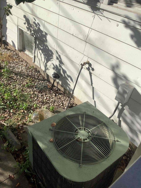 Conducted comprehensive duct cleaning estimate and system inspection for residential HVAC system. Evaluated outdoor condenser unit showing signs of age with debris accumulation on top grille and surrounding area, noted refrigerant line routing and overall equipment condition. Inspected crawl space ductwork and assessed accessibility for cleaning procedures, documenting vapor barrier configuration, PEX and PVC utility routing, and structural clearances beneath floor joists to determine scope of work required for thorough duct system cleaning and sanitization.