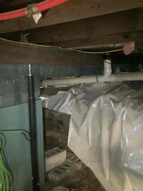 Conducted comprehensive duct cleaning estimate and system inspection for residential HVAC system. Evaluated outdoor condenser unit showing signs of age with debris accumulation on top grille and surrounding area, noted refrigerant line routing and overall equipment condition. Inspected crawl space ductwork and assessed accessibility for cleaning procedures, documenting vapor barrier configuration, PEX and PVC utility routing, and structural clearances beneath floor joists to determine scope of work required for thorough duct system cleaning and sanitization.