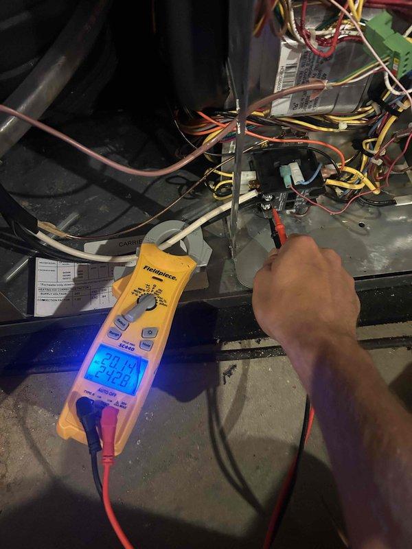 Responded to service call for geothermal heating system operating in emergency heat mode. Performed comprehensive diagnostic inspection of furnace and control systems using digital multimeter to test electrical components, connections, and voltage readings throughout the unit. Conducted pressure testing of the geothermal loop system using analog pressure gauge to verify proper refrigerant pressures and system operation. Inspected all wire harnesses, control modules, transformers, and safety circuits within the air handler compartment. Evaluated emergency heat operation and identified cause of system defaulting to auxiliary heat instead of utilizing geothermal heat pump. All findings documented and system restored to normal geothermal heating operation.