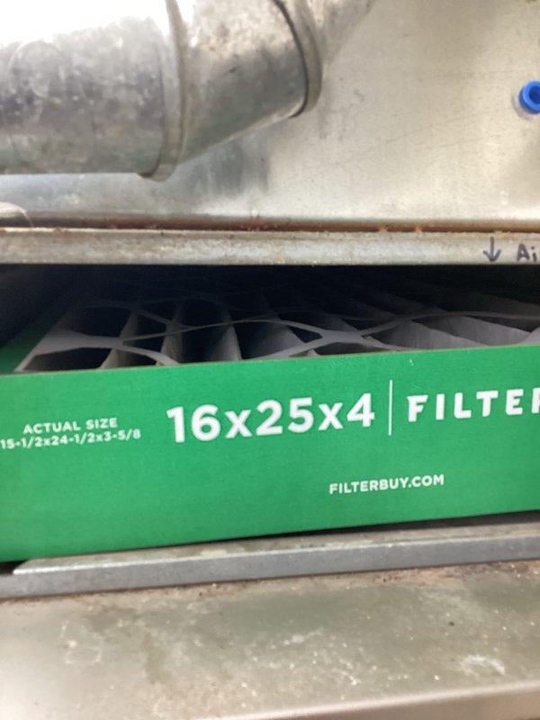 Completed monthly basic heating maintenance visit on residential HVAC system. Inspected 16x25x4 air filter housing and verified proper filter installation, observed thermostat operation displaying current temperature of 69°F with setpoint of 72°F in heating mode, and documented system components showing normal wear and dust accumulation on ductwork and filter housing area.