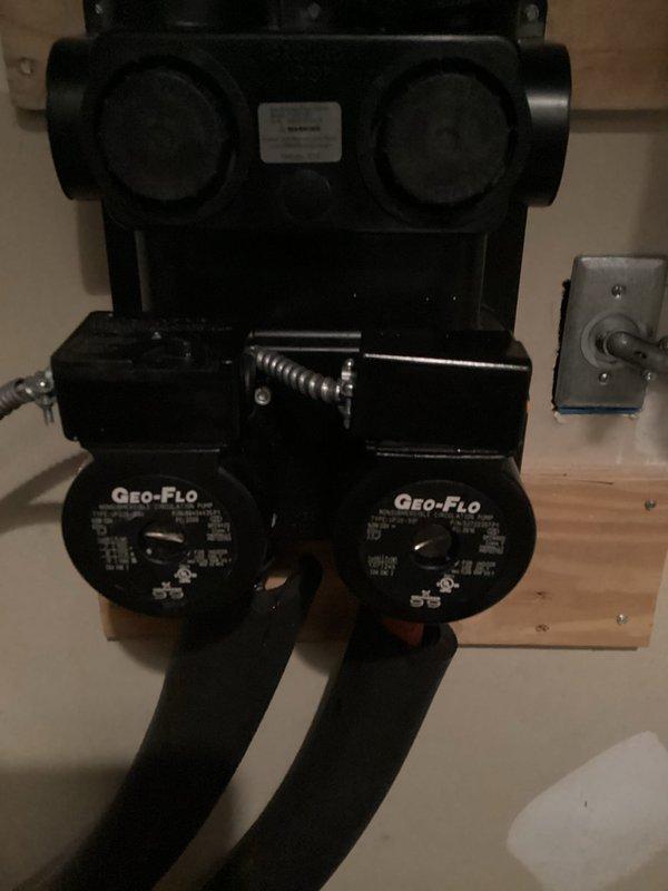 Replaced failed circulator pump on dual pump hydronic loop system. Removed defective right-side Geo-Flo circulator pump from wall-mounted manifold assembly and installed new replacement unit. Verified proper electrical connections and tested system operation to confirm adequate flow and function.