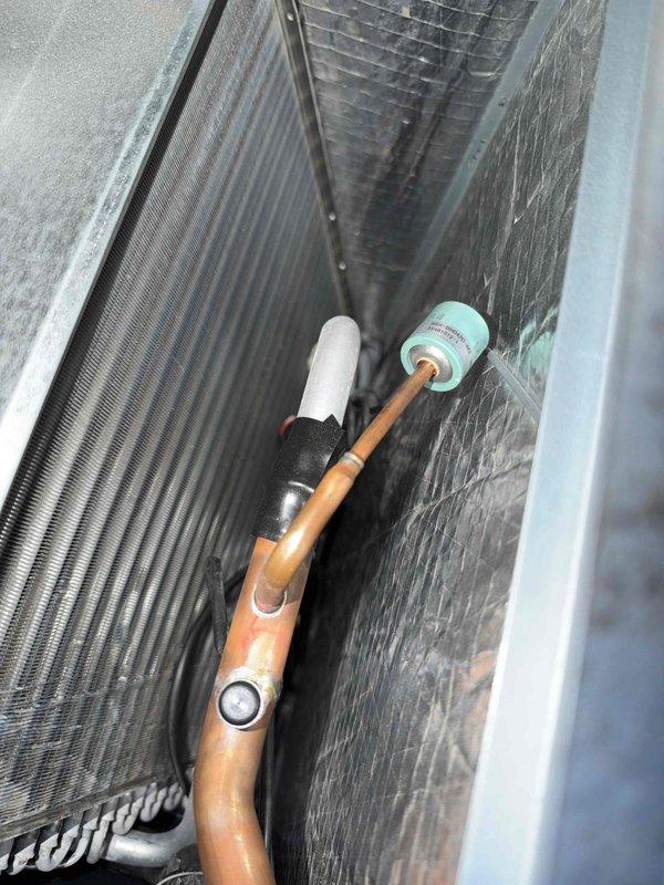 Completed basic monthly heating maintenance on CCHP system. Performed visual inspection of heat exchanger coils, which showed moderate dust and debris accumulation on fin surfaces. Inspected refrigerant lines, copper piping, and associated valve fittings; all connections appeared secure with proper insulation in place. Verified system components and documented equipment condition with photographs for service records.