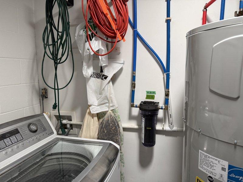 # Plumbing Install - Tanked Water Heater

Installed a 50-gallon Elite Energy heat pump water heater in utility room with complete plumbing and electrical connections. Connected hot and cold water supply lines using PEX piping, installed temperature and pressure relief valve with discharge piping, and established proper electrical service with dedicated circuit and junction box. All connections tested and verified operational with no leaks detected.