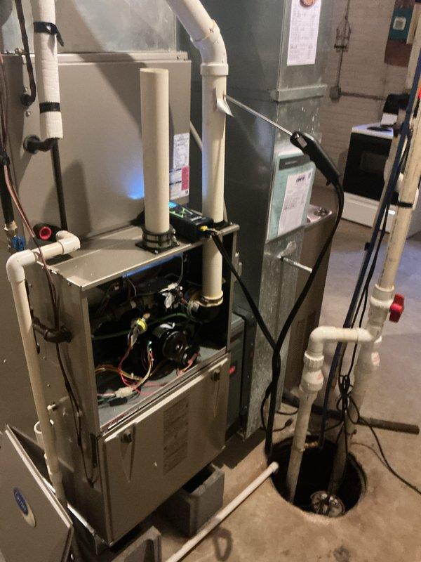 Completed annual heating maintenance visit on residential forced air furnace system. Performed comprehensive inspection of gas furnace, including burner assembly, heat exchanger, ignition system, and all safety controls. Verified proper operation of blower motor and checked airflow through system. Inspected venting system including white PVC intake and exhaust pipes for proper termination and secure connections. Tested thermostat functionality and verified proper system cycling. Examined electrical connections, wiring harnesses, and control board for signs of wear or damage. Confirmed all safety switches and limit controls operating within specifications. Checked condensate drain system for proper drainage. Inspected air handler cabinet and coil housing for any issues. System operating normally with all components functioning as designed. Customer advised that 20x25x4 filter is not included with service agreement and should be replaced as needed.
