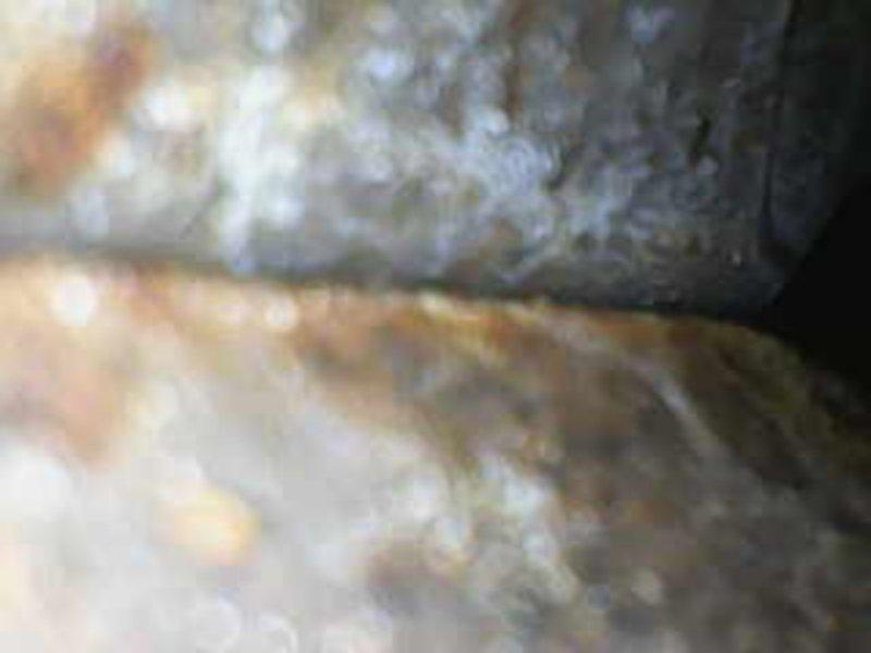 Responded to request for second opinion on heat pump system following previous service concerns. Conducted thorough inspection of heat pump components and associated piping systems. Documentation revealed significant corrosion and deterioration on refrigerant lines with visible rust staining and oxidation present on metal surfaces. Inspected insulation materials in confined access areas showing signs of age and weathering. Communicated findings directly with customer per request to discuss system condition, available options, and recommended corrective actions for the compromised components.