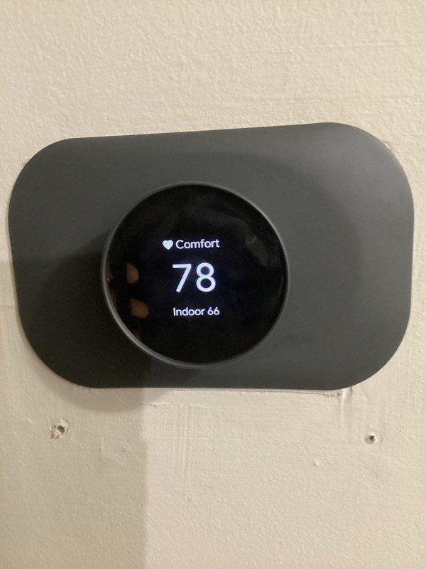 Completed quoted maintenance on geothermal system and guest house HVAC unit. Inspected smart thermostat displaying proper operation with current temperature readings and comfort settings functioning correctly. Discovered significant moisture damage, mold growth, and mineral deposits in mechanical compartment floor area with visible deterioration to insulation panels and surrounding surfaces requiring attention. Documented system conditions including copper refrigerant lines, condensate drainage components, and overall equipment accessibility for future reference and recommended remediation of biological growth and moisture intrusion issues.