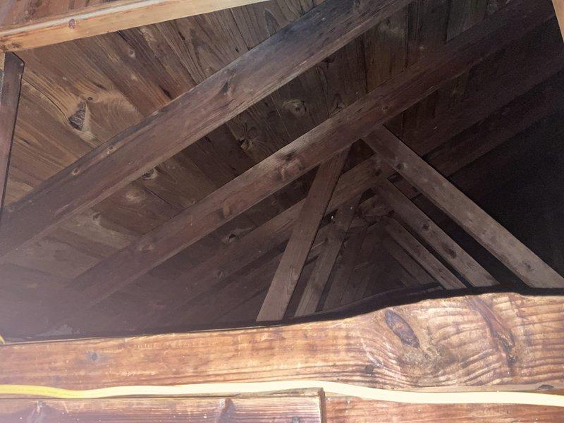 Completed comprehensive HVAC system replacement estimate for 27-year-old existing equipment. Customer requested full system replacement along with duct cleaning services and Sollaris indoor air quality product installation due to new baby in household. Documented attic space conditions including existing structural framework, insulation, and electrical wiring to assess installation requirements and access points for new equipment.