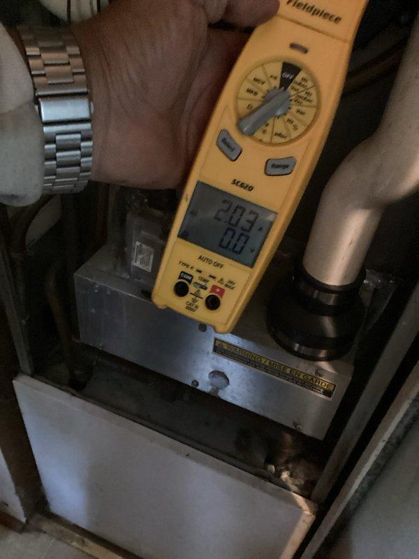 Responded to no-heat call on gas furnace that had been inoperative since previous winter. Upon arrival, found evaporator coil heavily loaded with dust and lint accumulation, restricting airflow throughout the system. Performed diagnostic testing with digital multimeter, recording voltage readings of 292.3V to verify electrical supply and system functionality. Inspected furnace components and refrigerant lines, noting significant debris buildup requiring cleaning to restore proper operation. System age unknown at time of service visit.