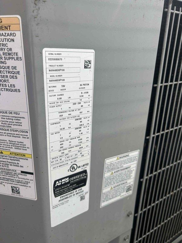 Responded to service call for A/C system producing buzzing noise with warm refrigerant outlet line. Inspected air handler unit and verified TXV metering system operation on unit model N41644DXP100. Diagnosed compressor issue causing abnormal noise and improper heat rejection at discharge line, documented unit specifications and current operating conditions with photos for service records.