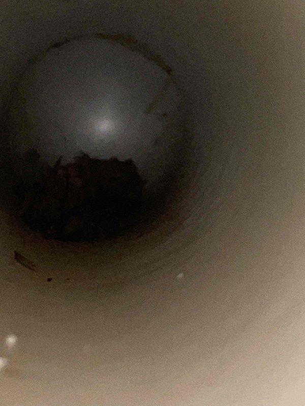 Responded to service call for flue pipe restriction issue. Upon inspection, located blockage within the PVC flue pipe system but was unable to complete removal due to equipment limitations—the shot back hose could not reach the obstruction point. Return visit will be required with extended reach equipment to properly clear the restriction and restore proper venting function.