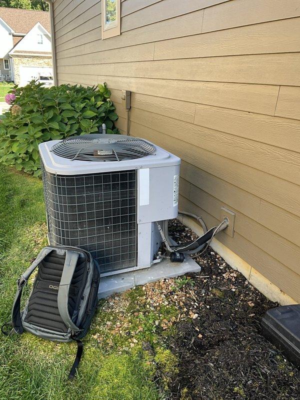 Performed an on-site evaluation for replacement of the existing heating system, including inspection of the associated ancillary equipment. Documented the Honeywell whole-house ventilation control and Aprilaire humidity control mounted on the supply duct, along with the exterior air conditioning condenser, which showed no visible frost, rust, or damage. Gathered system information to prepare a replacement estimate for the homeowner to compare against competing quotes.