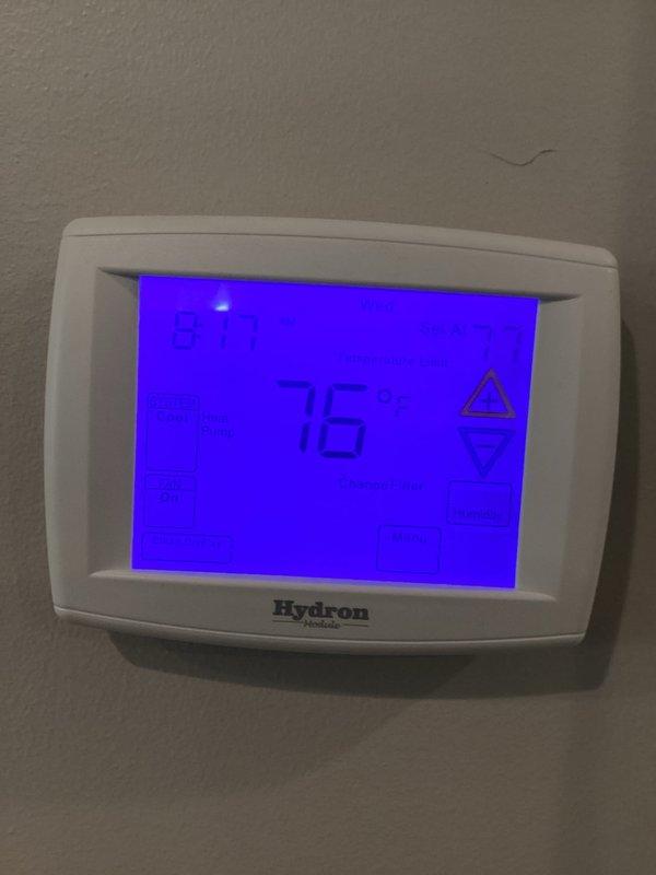 Performed annual heating maintenance on two systems, including inspection of thermostat operation and verification of heat pump mode and fan settings. Measured supply duct temperature at approximately 100.7°F to confirm proper heating output, and noted the thermostat's filter change reminder for the homeowner's attention.
