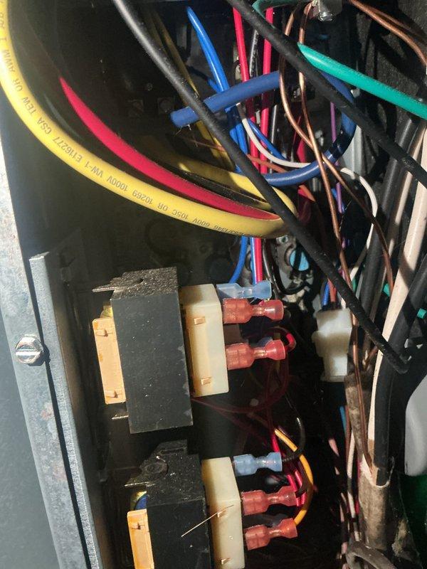 Performed a complete seasonal tune-up on the Daikin furnace and heat pump system, inspecting the electrical control compartment, wiring connections, and air handler interior. Documented heavy dust and debris buildup on the evaporator coil fins and surrounding cabinet surfaces, along with loosely routed control wiring, and verified the system was operating normally with no faults or performance issues reported.