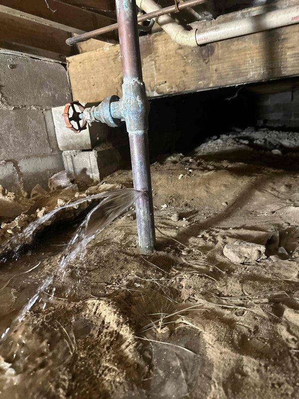 Replaced the failed main water line shut-off valve in the crawl space, which was leaking at the tee fitting and showing heavy corrosion on the surrounding copper. Isolated the water supply, removed the compromised valve, and installed a new brass ball valve with press-style copper fittings. Pressure tested the connection and confirmed leak-free operation.