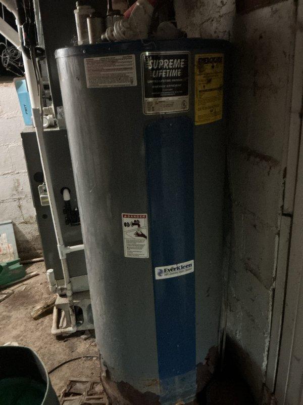 Performed scheduled monthly heating maintenance on the Lennox ML196UHE Merit Series gas furnace, including replacement of the 16x25x1 air filter and inspection of the unit's operating condition and service history documentation. Observed no frost, ice, or major damage at the furnace; noted heavy rust and corrosion at the base of the adjacent water heater tank, recommending that it be monitored or evaluated for replacement.