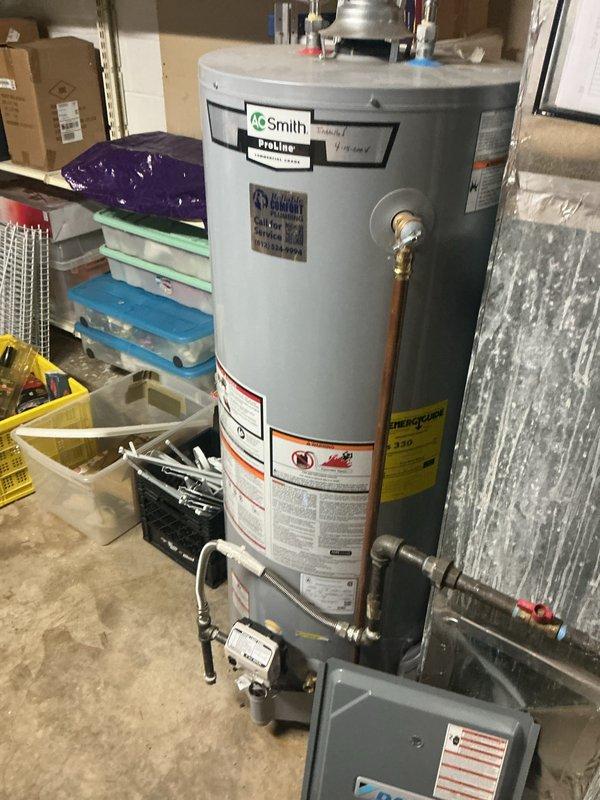 Performed monthly preventive maintenance inspection on a gas-fired Daikin furnace, removing the lower access panel to inspect the gas valve, blower motor, wiring harness, and Honeywell control module, and verifying operation with a digital meter. Checked gas piping, flexible connectors, shutoff valves, PVC condensate/vent piping, and ductwork connections for leaks or damage, with no frost, rust, or deficiencies noted. Visually inspected the adjacent A.O. Smith commercial water heater, including flue, gas connections, and piping, with no visible damage or issues; air filter replacement was not included in this visit.