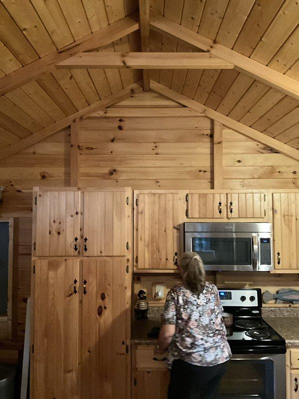 Performed an on-site assessment for a ductless mini split installation in a 500 sq ft cabin with vaulted knotty pine ceilings. Evaluated the kitchen's upper wall above the cabinetry as the proposed indoor air handler location, accounting for the open vaulted layout and nearby electrical service. Documented site conditions with photos to support equipment sizing, line set routing, and electrical requirements for the installation proposal.