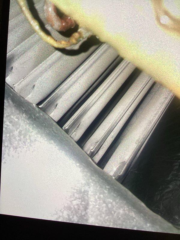 Performed scheduled monthly heating system maintenance, including replacement of the 20x25x1 air filter and verification of thermostat operation and system status. Borescope inspection of the coil revealed bent and dented fins along with signs of corrosion on adjacent components; recommend monitoring and follow-up evaluation to maintain optimal airflow and heat transfer efficiency.