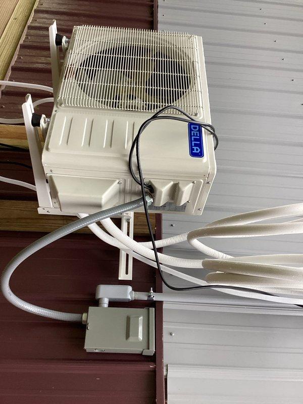 Performed a vacuum evacuation of the refrigerant lines on a Della ductless mini split system to remove air and moisture prior to system operation. Inspected the outdoor condenser, line set insulation, and electrical disconnect connections, finding the equipment secure, clean, and free of visible damage, frost, or corrosion.