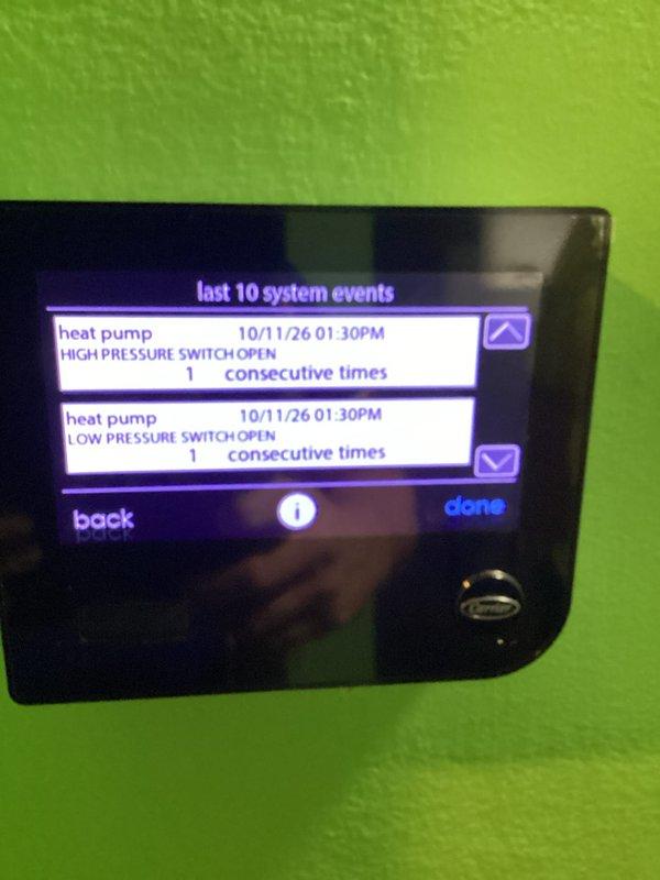 Responded to a non-functioning Carrier touchscreen thermostat and found the system event log recording simultaneous high and low pressure switch open faults on the heat pump. Inspected the outdoor condenser unit and its disconnect, and documented the thermostat fault history and unit data for manufacturer warranty verification. Further diagnosis of the refrigerant circuit and pressure switch operation is recommended, and the thermostat is to be evaluated for warranty replacement.