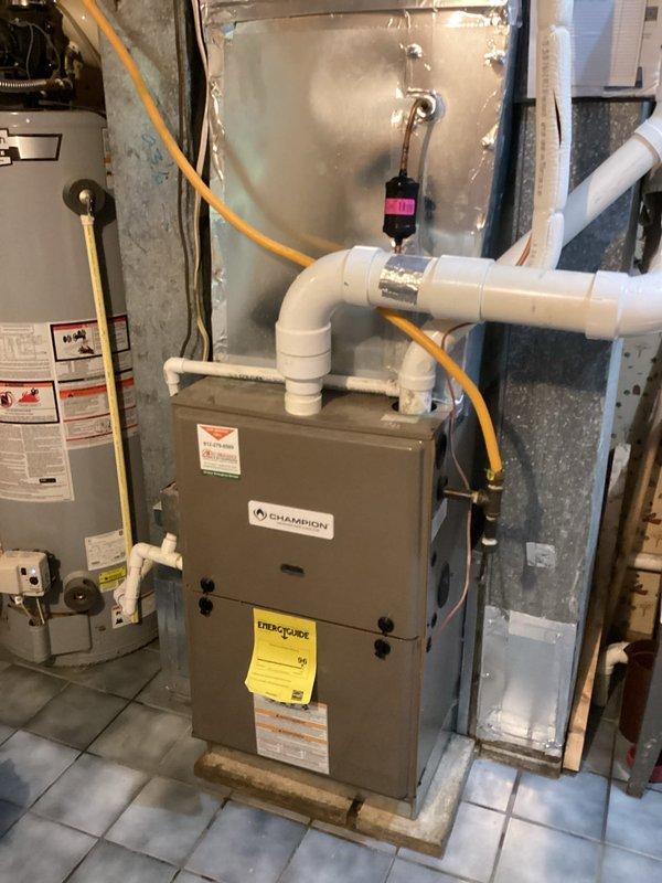 Responded to a no-cooling complaint with the outdoor unit running and moisture present at the air handler. Found the thermostat set to System: Off at 75°F indoor temperature; inspected the furnace/air handler assembly, condensate drain piping, and refrigerant line set, then verified proper operation of the cooling system with the thermostat set to cool.