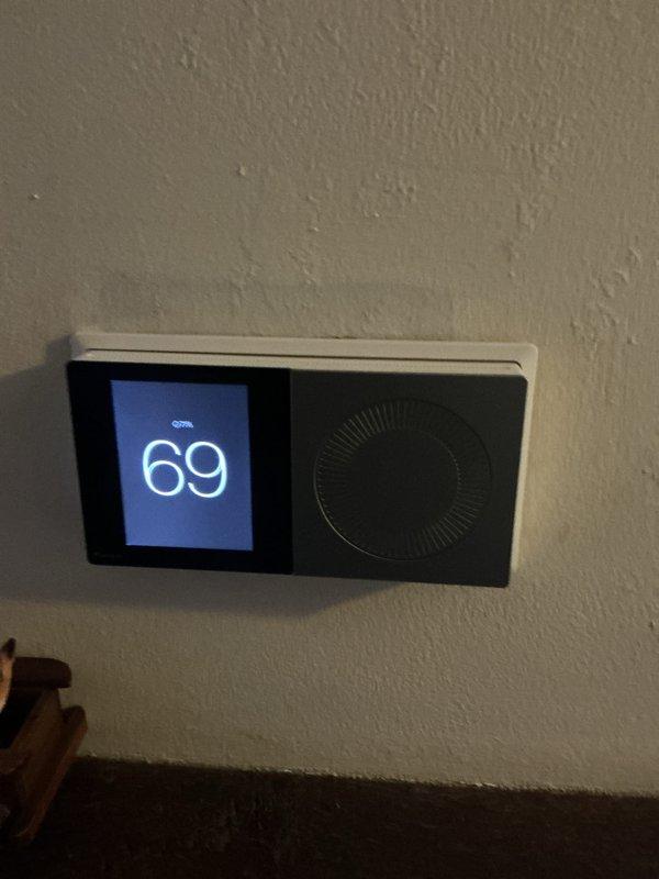 Performed a heating system maintenance visit under an expired-but-owed service plan, inspecting the wall-mounted digital thermostat (reading 69°F) and the air handler/ductwork in the utility closet. A 20x20x4 MERV 11 pleated filter was on site for the system but was not included in the scope of the visit, and the filter's airflow arrow should be matched to the air handler's direction when it is installed.